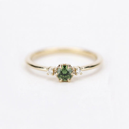 Yellow gold three-stone petal ring with a round green sapphire and two diamonds, front view