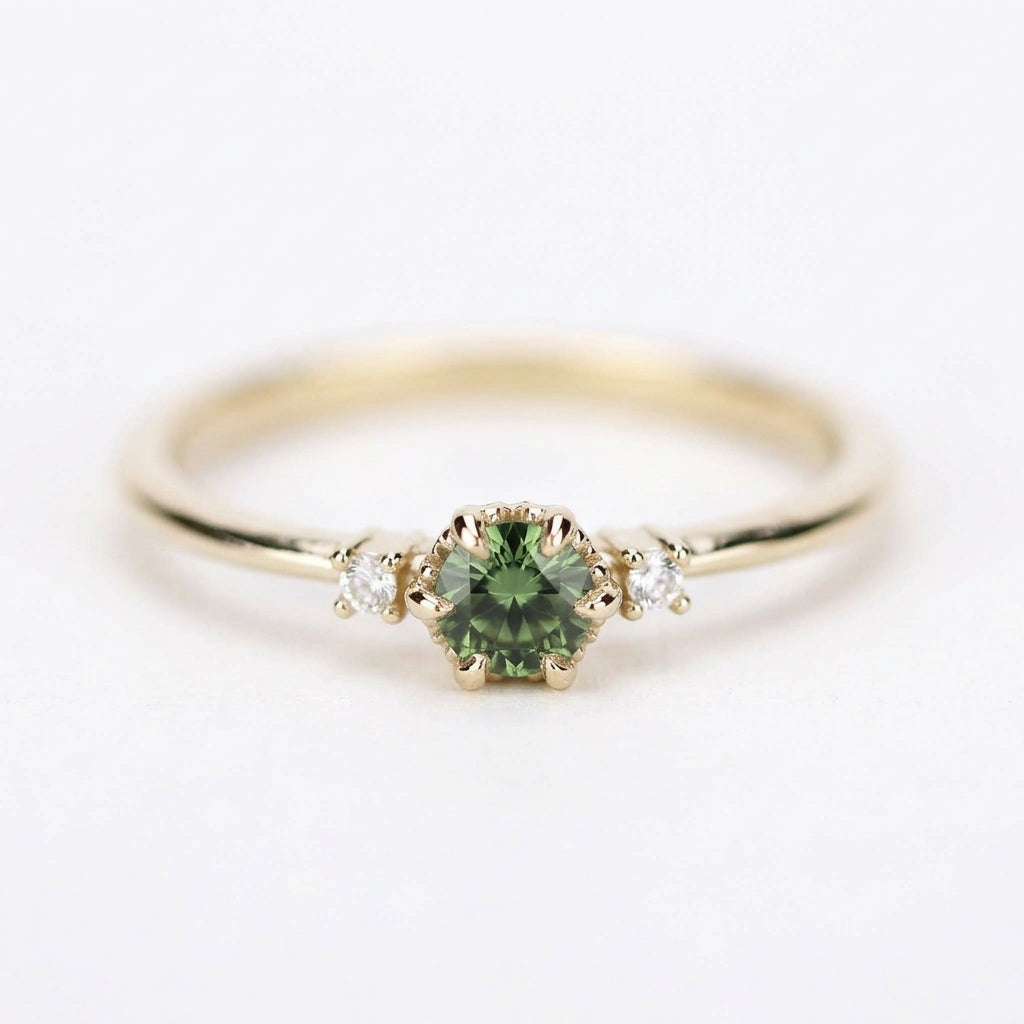 Yellow gold three-stone petal ring with a round green sapphire and two diamonds, front view