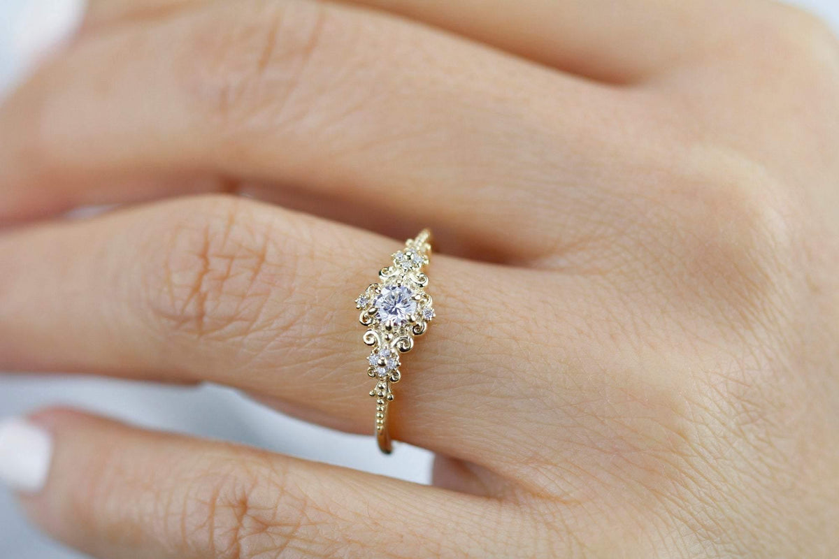 18k gold art deco ring with a round lab grown diamond, worn on the hand, top view
