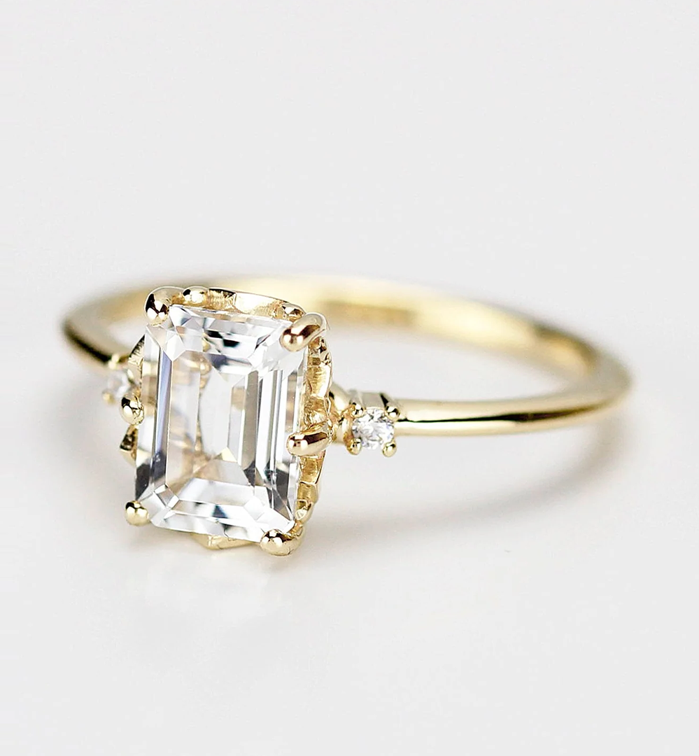 Emerald-cut moissanite engagement ring in 18k yellow gold