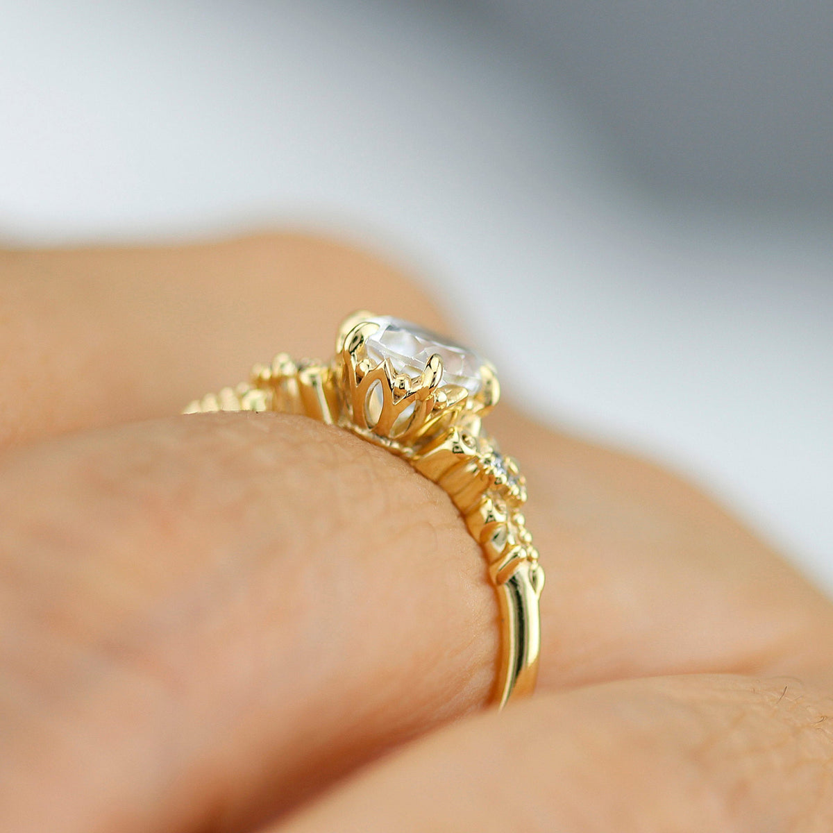 18k gold vintage ring with a 1 carat oval lab grown diamond, worn on the hand, side view