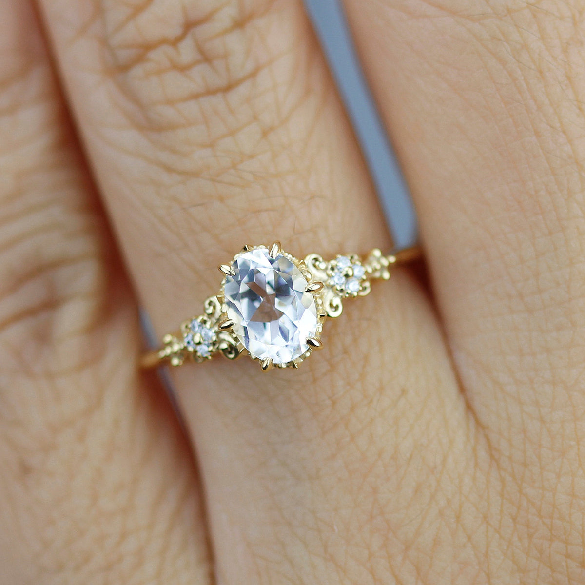 18k gold vintage ring with a 1 carat oval lab grown diamond, worn on the hand, top view