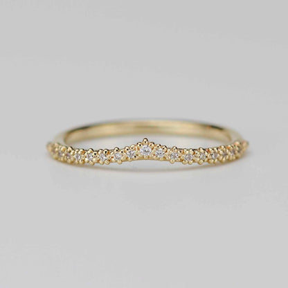 18k yellow gold chevron wedding band with 17 diamonds in a beaded crown tiara setting on a white background.