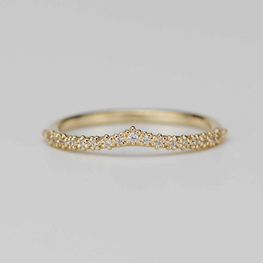 18k yellow gold chevron wedding band with 17 diamonds in a beaded crown tiara setting on a white background.