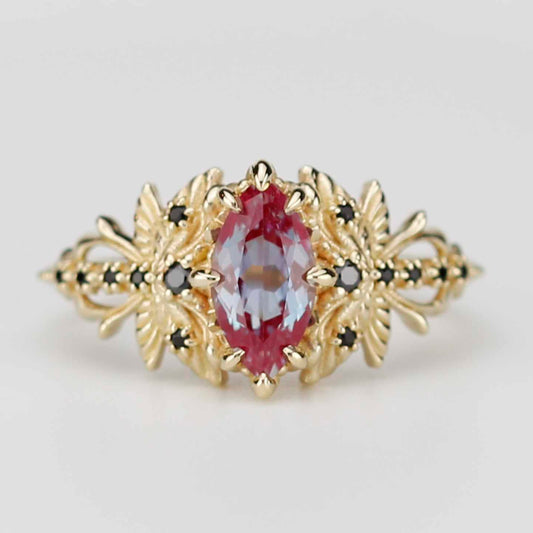 18k yellow gold dragonfly ring featuring a marquise-cut lab alexandrite center stone and black diamond accents on a white background.