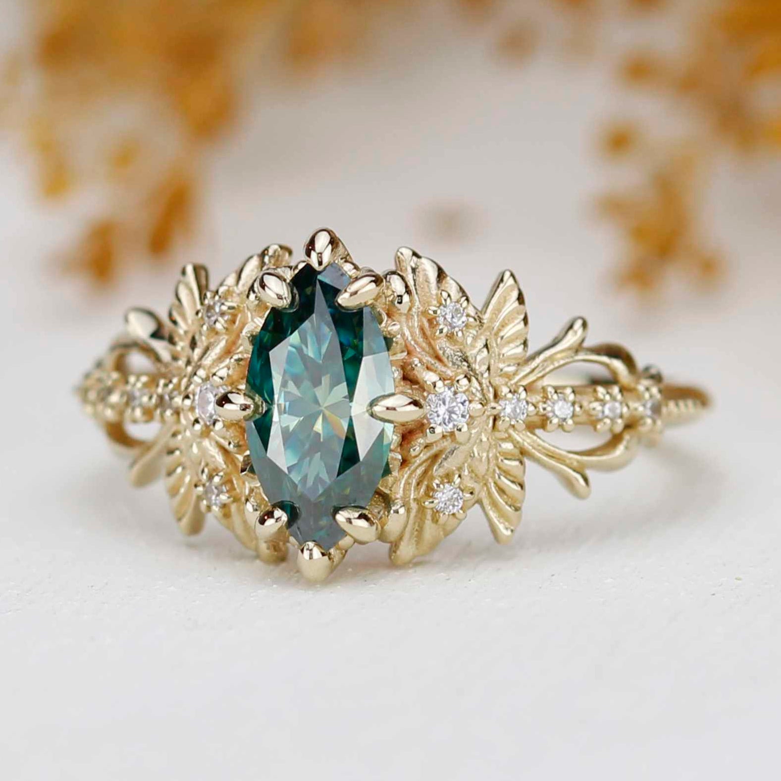 18k yellow gold dragonfly ring with marquise forest green moissanite and natural diamonds.