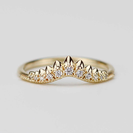 Front view of a contoured 18k yellow gold crown wedding band featuring a sunburst of natural white diamonds in a pointed chevron setting on a white background.