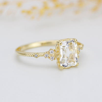 18k gold ring with an emerald cut lab grown diamond, angled view