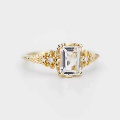 18k gold vintage floral ring with an emerald cut lab grown diamond, angled view