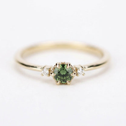 Yellow gold three-stone petal ring with a round green sapphire and two diamonds, front view