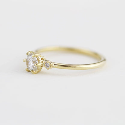 18k gold three stone ring with a round lab grown diamond, side view