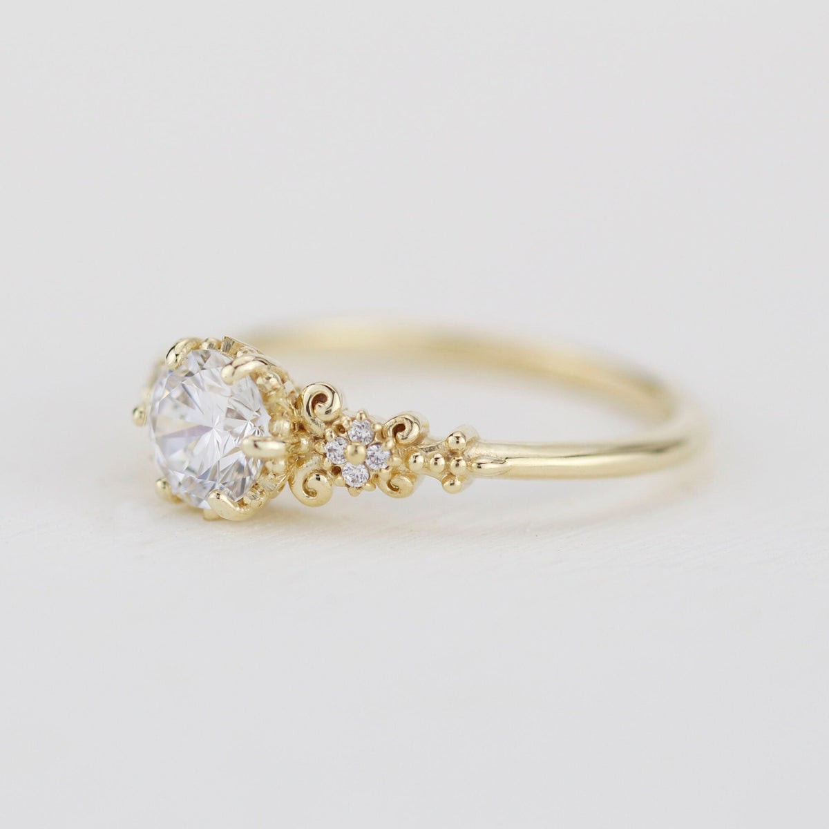 18k gold baroque cluster ring with a 0.8 carat round lab grown diamond