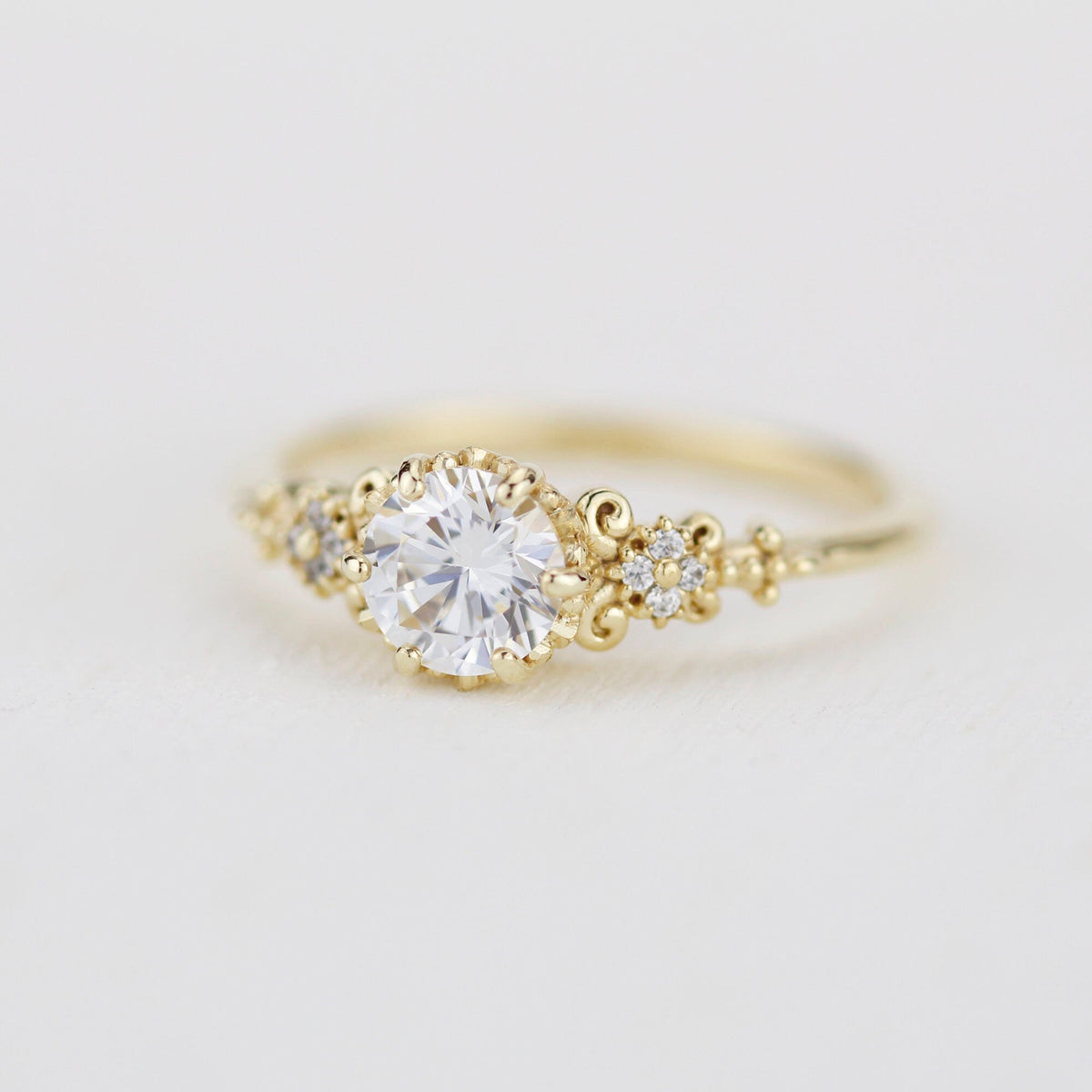 18k gold baroque cluster ring with a 0.8 carat round lab grown diamond