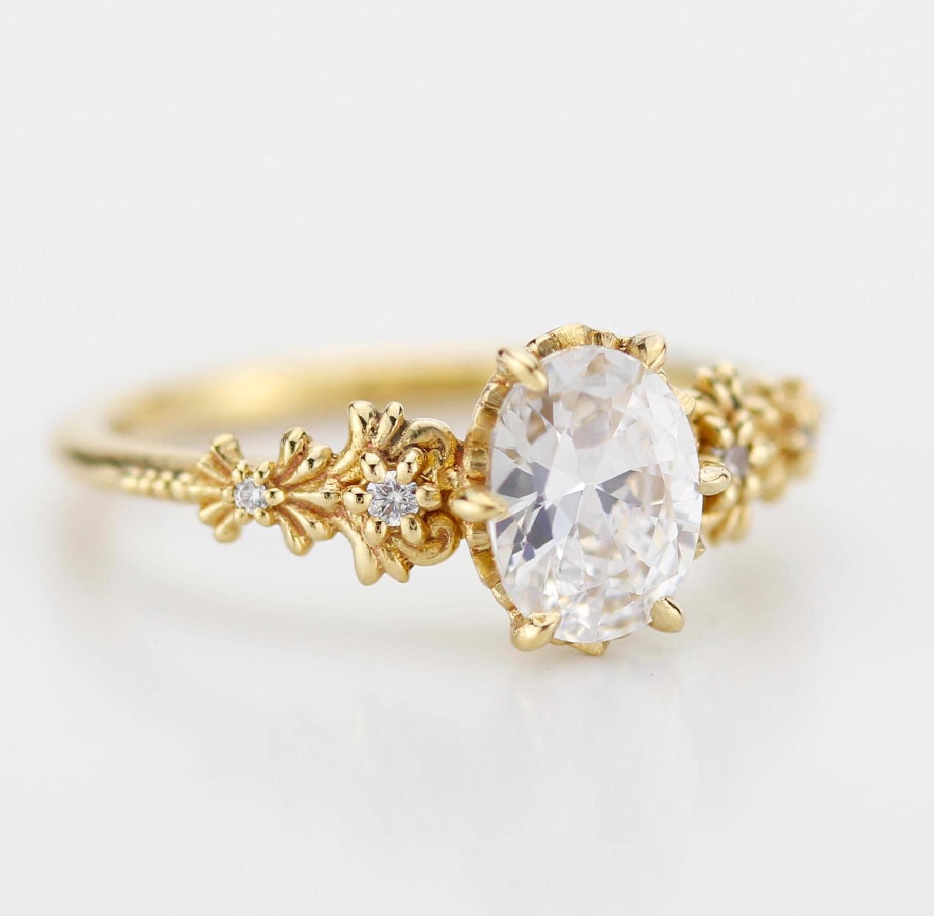 Baroque-style oval Moissanite ring with real Moissanite center stone and diamond accents on the sides, featuring elegant vintage-inspired detailing and ornate curves for a timeless and luxurious look.