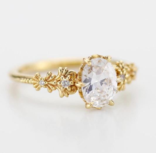 Baroque-style oval Moissanite ring with real Moissanite center stone and diamond accents on the sides, featuring elegant vintage-inspired detailing and ornate curves for a timeless and luxurious look.