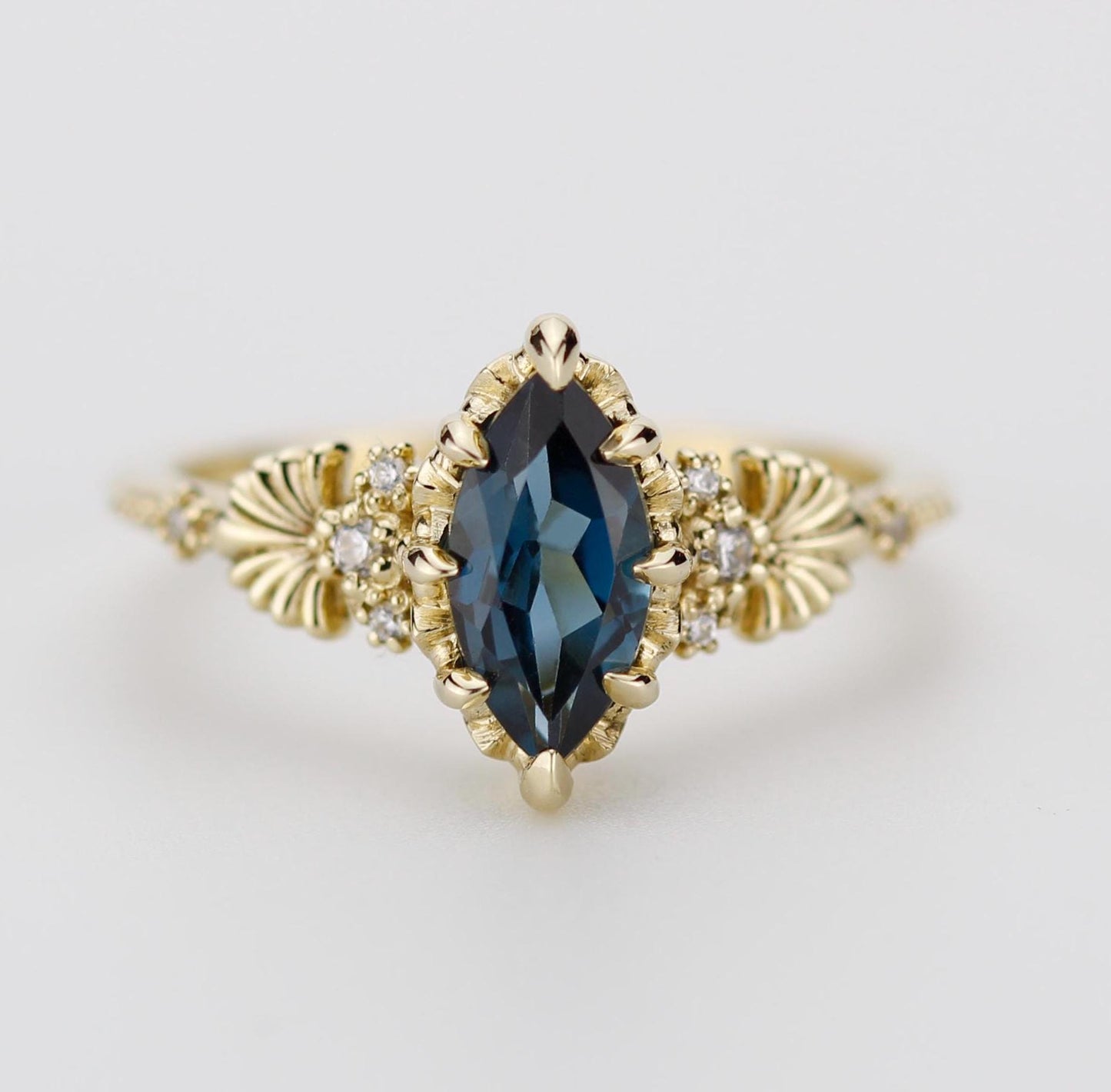 "Elegant 18k solid gold ring featuring a marquise-shaped 10x5mm Natural London Blue Topaz gemstone, accented with sparkling natural diamonds and intricate vintage-inspired detailing on the band."