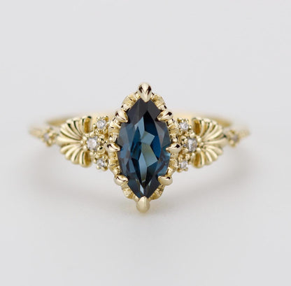 "Elegant 18k solid gold ring featuring a marquise-shaped 10x5mm Natural London Blue Topaz gemstone, accented with sparkling natural diamonds and intricate vintage-inspired detailing on the band."