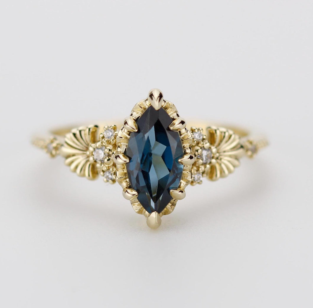 "Elegant 18k solid gold ring featuring a marquise-shaped 10x5mm Natural London Blue Topaz gemstone, accented with sparkling natural diamonds and intricate vintage-inspired detailing on the band."
