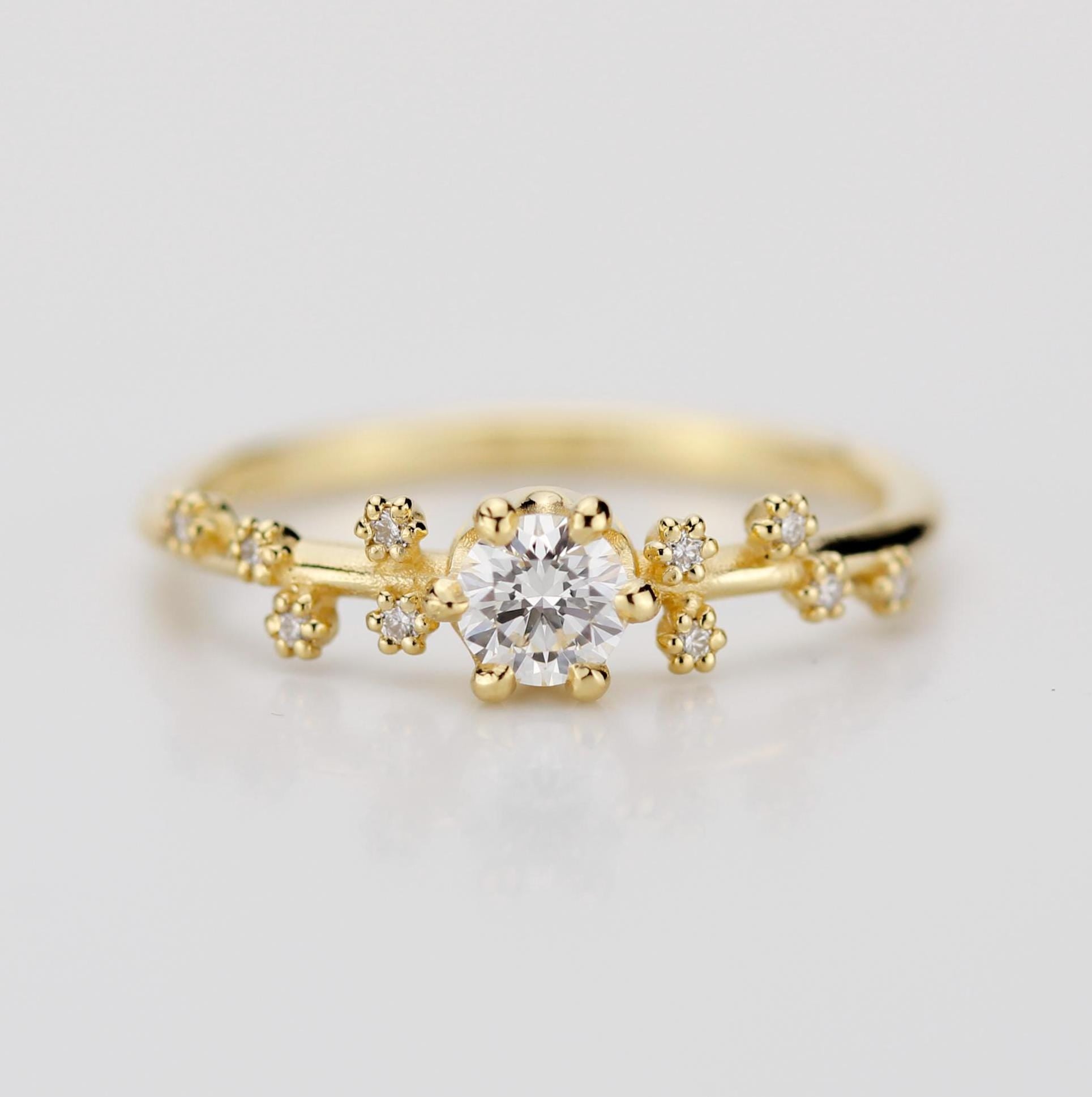 A celestial-inspired 18K gold engagement ring with a 0.25ct natural diamond at the center, accented by diamond side stones arranged in the shape of the Big Dipper constellation, symbolizing guidance and connection to the stars.