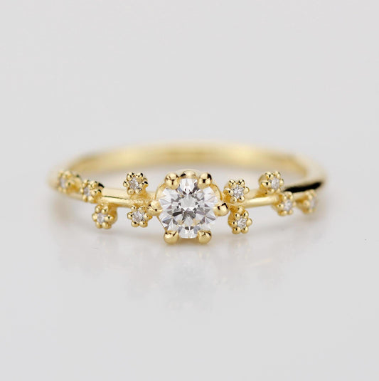 A celestial-inspired 18K gold engagement ring with a 0.25ct natural diamond at the center, accented by diamond side stones arranged in the shape of the Big Dipper constellation, symbolizing guidance and connection to the stars.
