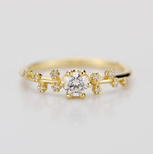 Load image into Gallery viewer, A celestial-inspired 18K gold engagement ring with a 0.25ct natural diamond at the center, accented by diamond side stones arranged in the shape of the Big Dipper constellation, symbolizing guidance and connection to the stars.
