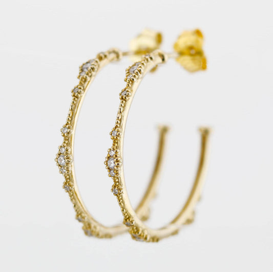 Close-up of elegant 18K solid gold hoop earrings with natural diamond accents and delicate beaded detailing, set against a white background. Luxurious fine jewelry for women, perfect for everyday wear or special occasions.