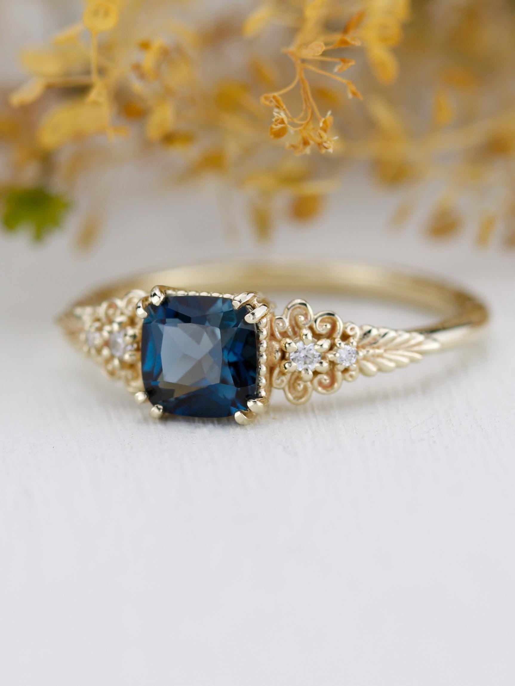 A vintage-inspired 18K gold ring featuring a cushion-cut topaz, accented with delicate filigree details and natural diamonds, creating an antique-style engagement or heirloom ring.