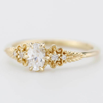 A vintage-inspired 18K gold ring featuring a certificated, accented with delicate filigree details and natural diamonds, creating an antique-style engagement or heirloom ring.