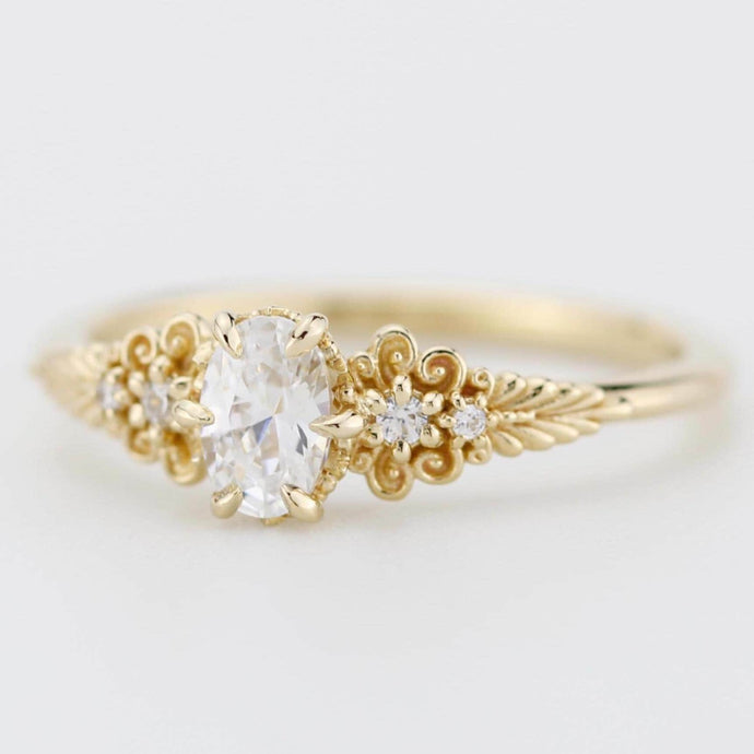 A vintage-inspired 18K gold ring featuring a certificated, accented with delicate filigree details and natural diamonds, creating an antique-style engagement or heirloom ring.