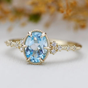 18k gold ring with Oval Sky Blue Topaz  set with 6 prongs  and Diamond engagement ring