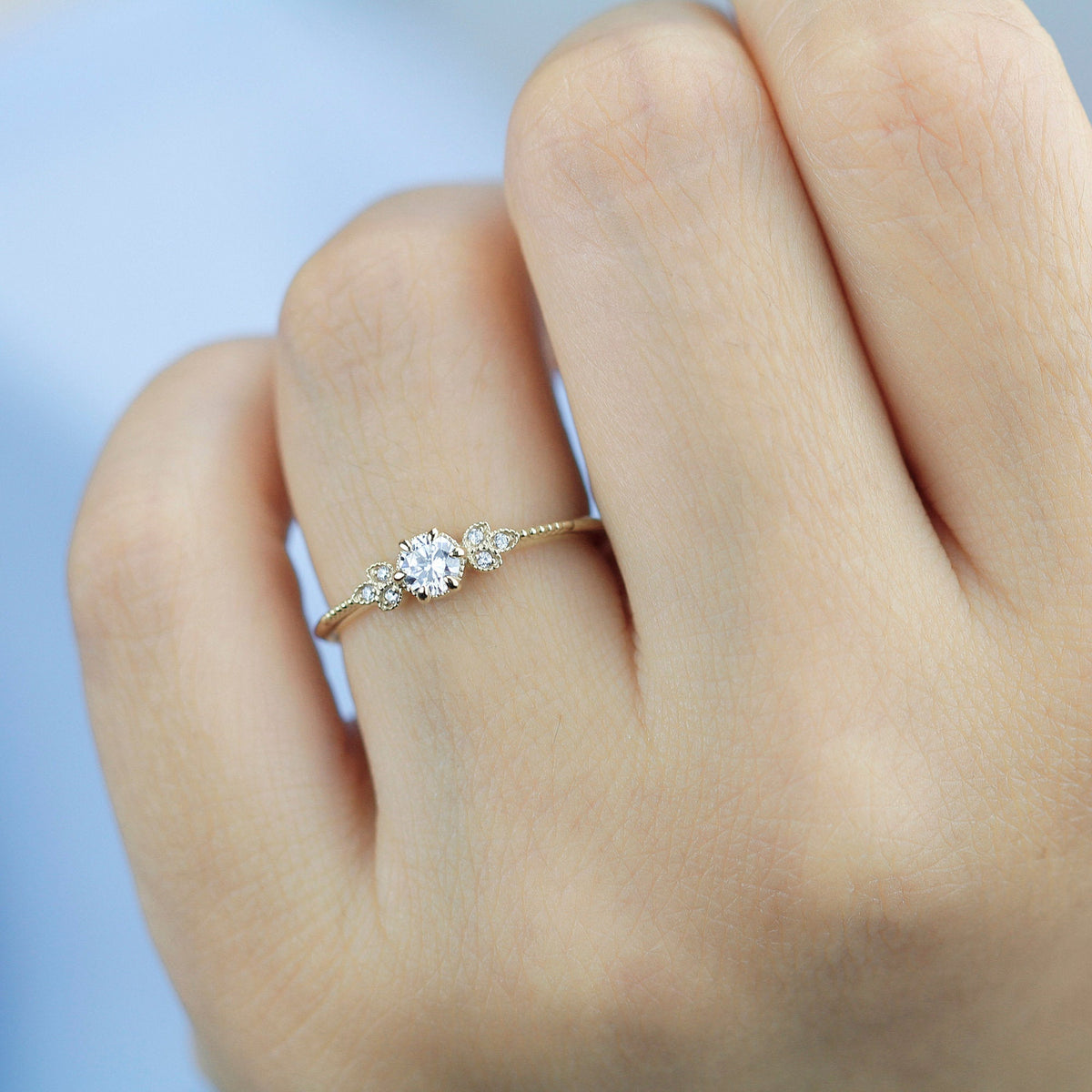 18k gold art deco leaf ring with a round lab grown diamond, worn on the hand, closer