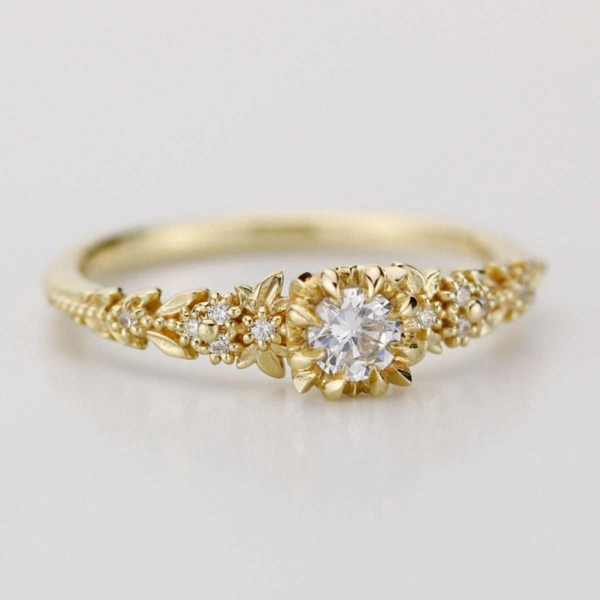 18k gold briar rose ring with a round lab grown diamond, angled view