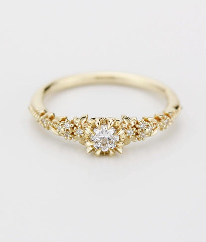 18k gold briar rose ring with a round lab grown diamond, front view on white