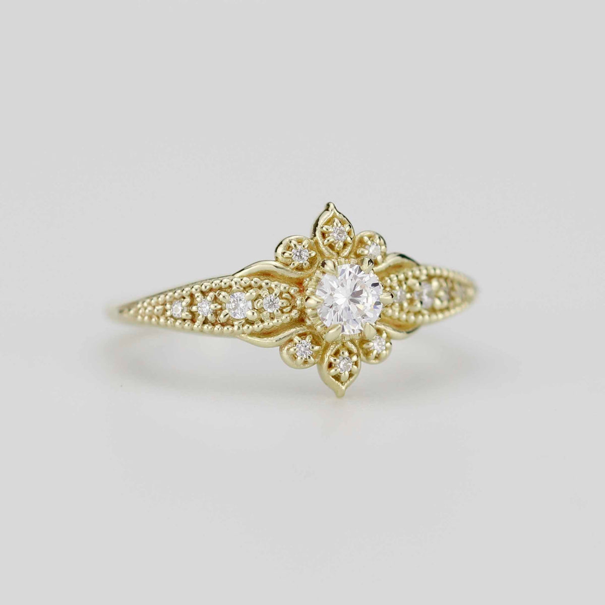 18k gold Dhalia ring with a round lab grown diamond, angled view