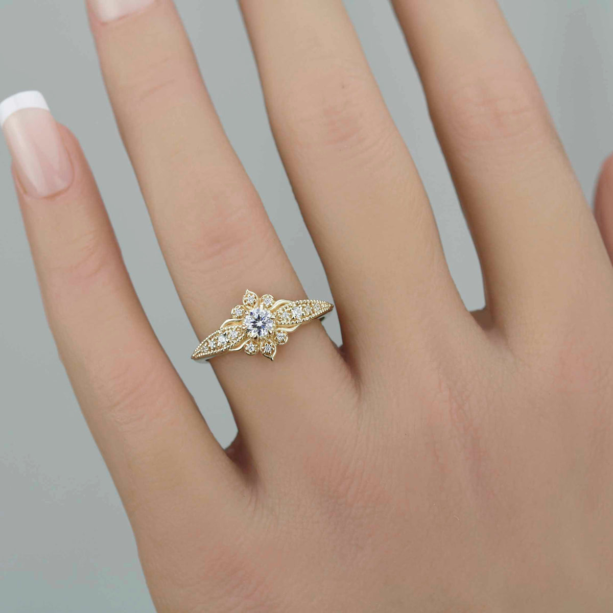18k gold Dhalia ring with a round lab grown diamond, worn on the hand
