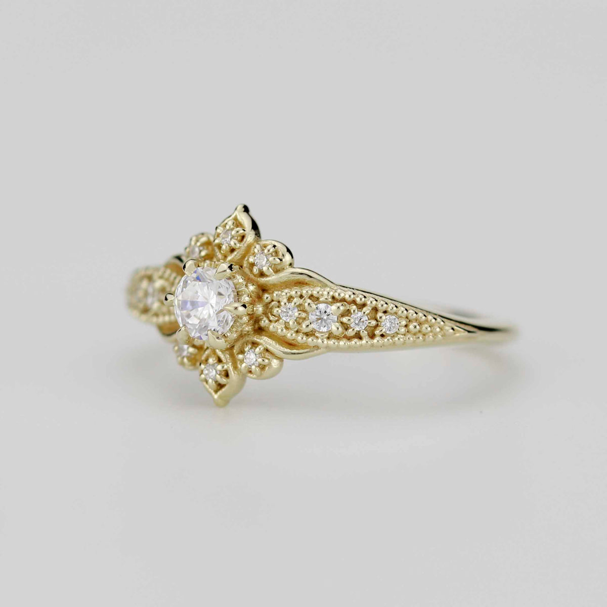 18k gold Dhalia ring with a round lab grown diamond, side view of the flower