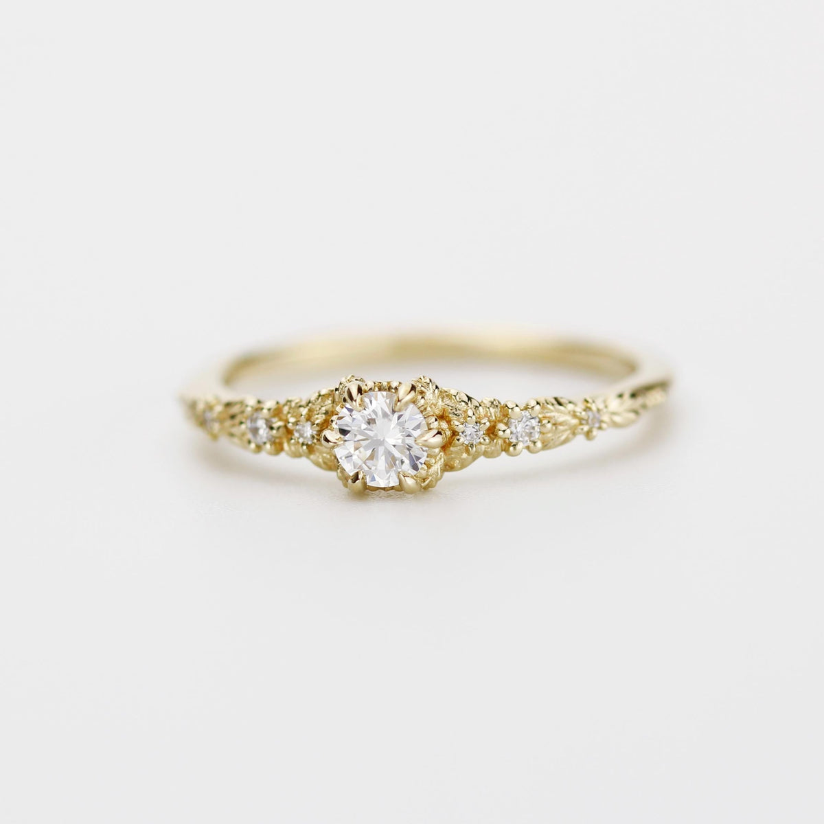 18k gold milgrain leaf ring with a round lab grown diamond, angled view