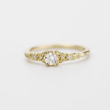 18k gold milgrain leaf ring with a round lab grown diamond, angled view