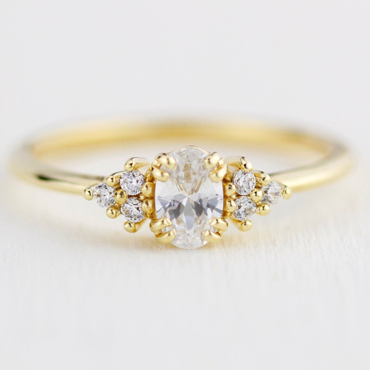 18k gold cluster ring with an oval lab grown diamond, about 0.45 carat, 6x4 mm