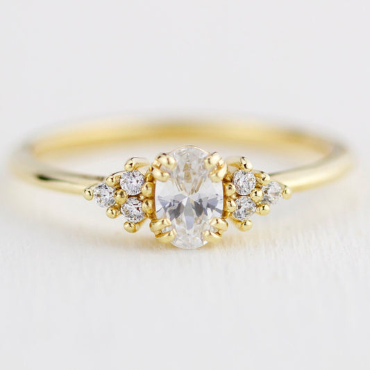 18k gold cluster ring with an oval lab grown diamond, about 0.45 carat, 6x4 mm