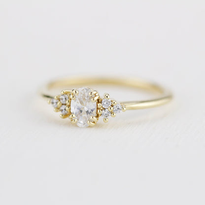 18k gold cluster ring with an oval lab grown diamond, angled view