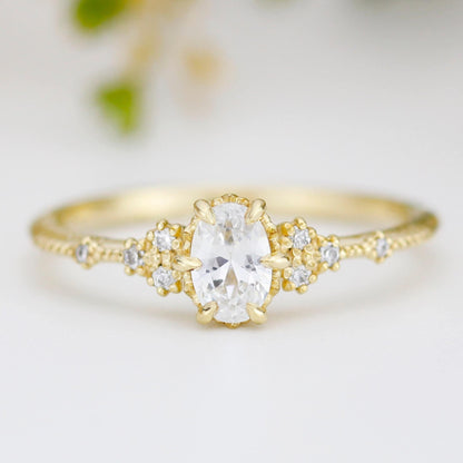 18k gold floral ring with a 6x4 mm oval lab grown diamond, about 0.45 carat