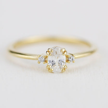 18k gold three-stone ring with a 6x4 mm oval lab grown diamond, about 0.45 carat
