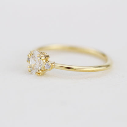 18k gold three-stone ring with an oval lab grown diamond, side view