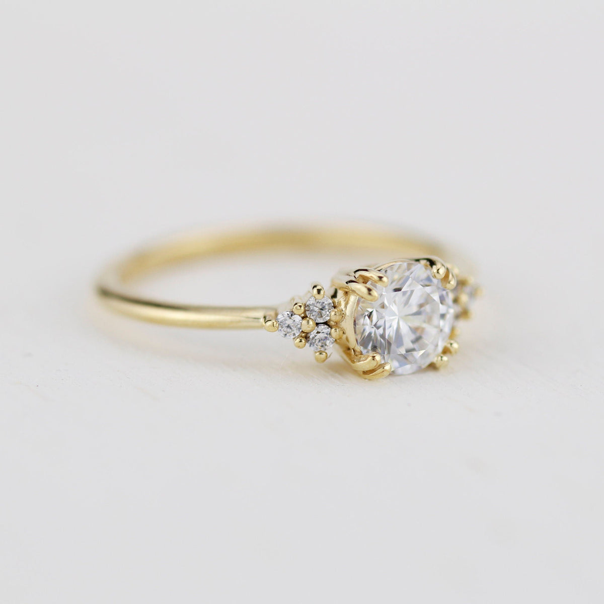 18k gold split-prong ring with a round lab grown diamond, angled view