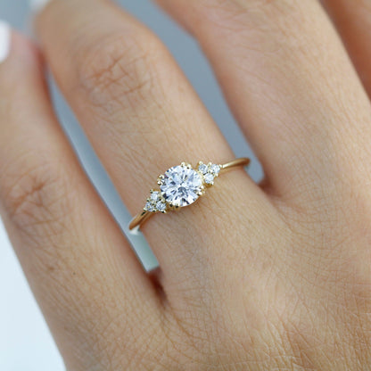 18k gold split-prong ring with a round lab grown diamond, worn on the hand