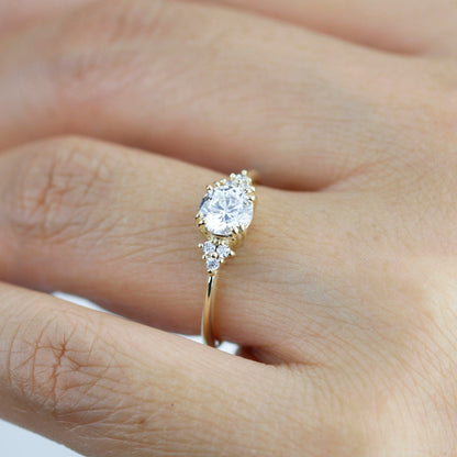 18k gold split-prong ring with a round lab grown diamond, worn on the hand, angled view