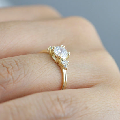18k gold split-prong ring with a round lab grown diamond, worn on the hand, side view