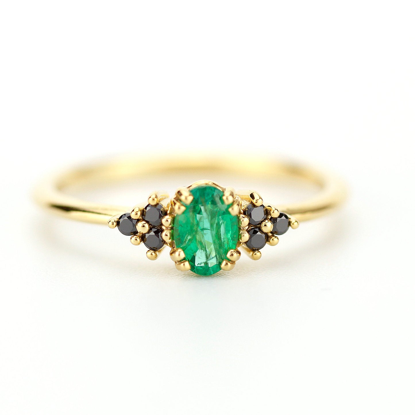 Emerald engagement ring with oval natural green emerald securely set with 8 claws 4 double claws, Natural  black diamonds as side gemstones