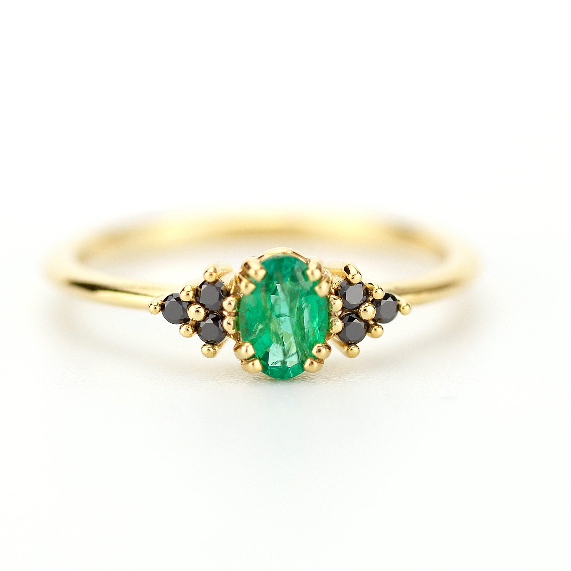 Emerald engagement ring with oval natural green emerald securely set with 8 claws 4 double claws, Natural  black diamonds as side gemstones